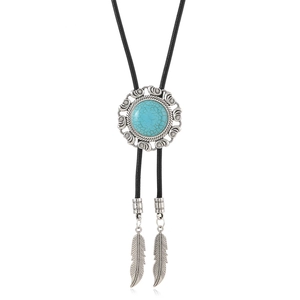Detail of vintage bolo tie with turquoise stone, braided leather cord and silver feather tips