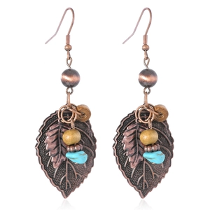 Detail of bohemian drop earrings featuring antique bronze leaf and turquoise stone