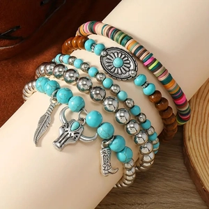 Five-piece bohemian beaded bracelet set featuring feather, bull skull, and boot charms