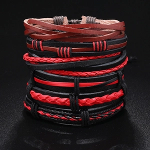 Detailed close-up of multilayered leather bracelets with woven ropes and red accents