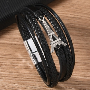 Detailed close-up of Bohemian leather bracelet featuring an Eiffel Tower metal pendant