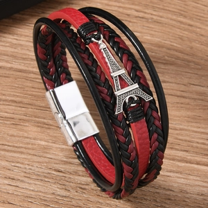 Multilayer leather bracelet with Eiffel Tower charm on a rustic wooden texture
