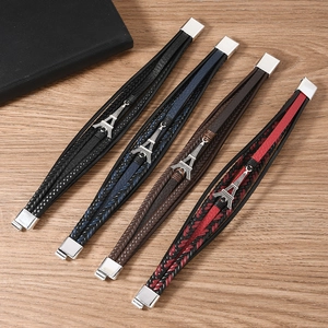 Detail of multi-layer woven leather bracelets featuring Eiffel Tower metal charms