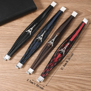 Detailed view of multilayer woven leather bracelets with Eiffel Tower metal charms