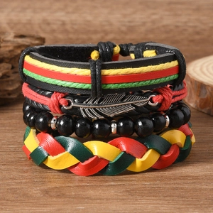 Détail d'un ensemble de bracelets en cuir style Rasta avec pendentif plume argentée