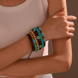 Detail showing layered bohemian bracelet set with turquoise beads and brown leather strap