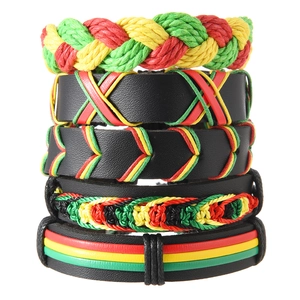 Detail view of 5-piece Jamaica style braided leather bracelets in red yellow and green
