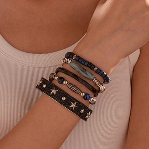 Detail view of bohemian multi-layer bracelets with blue beads and denim star cuff