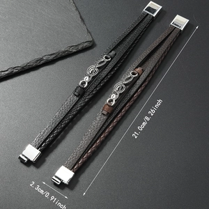 Detail view of multilayer braided leather music bracelets with magnetic clasp in black and brown