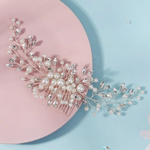 Detail of handmade silver bridal hair comb with pearls and marquise crystals