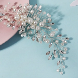 Detailed macro view of handmade bridal hair comb with silver wire pearls and rhinestones