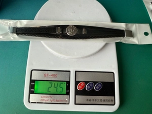 Detailed view of Tree of Life men leather bracelet on a digital scale weighing 24.5g