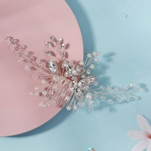 Macro detail of handmade bridal hair comb with crystal butterflies and pearls
