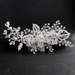 Macro view of silver floral bridal hair comb with shimmering rhinestones and pearls
