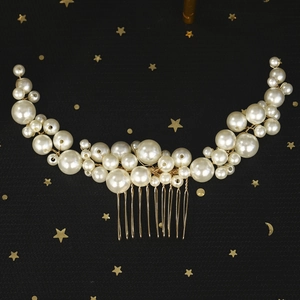 Elegant pearl bridal hair comb with gold wire hand-woven beads on a star-themed background