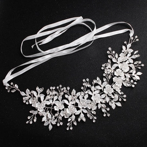 Detailed view of bridal headband featuring silver metal flowers and shimmering rhinestones