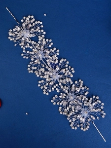 Close-up of bridal crystal hairband with marquise rhinestones and silver wire flowers