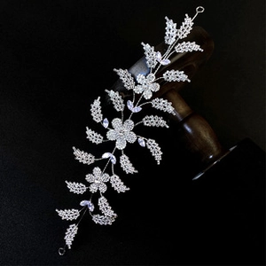 Detailed macro of a silver bridal hair vine with sparkling zircons and purple gems
