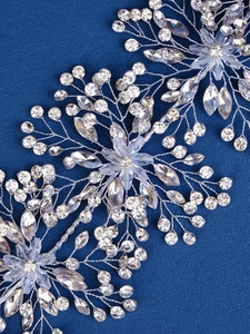 Close-up of handmade silver bridal headband with crystal leaves and rhinestone tassels