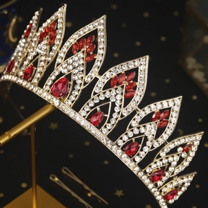 Detail of luxury bridal tiara with red rubies and white crystals on a gold setting