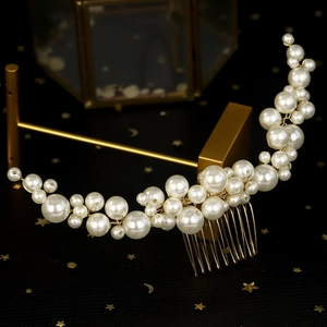 Detail of handmade pearl hair comb featuring gold wire weaving for bridal hairstyles