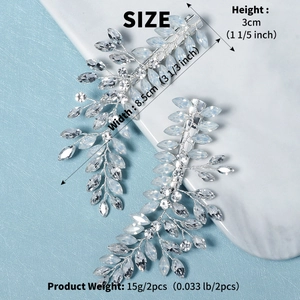 Detailed macro view of leaf-shaped crystal bridal hair clips with silver base and marquise stones