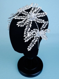 Macro shot of silver bridal headpiece with crystal leaves and rhinestone tassels details
