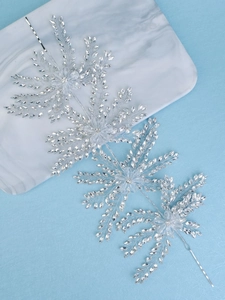 Detailed view of silver bridal headband with crystal snowflakes and tassel rhinestones
