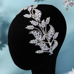 Detailed macro view of silver bridal headband with intricate zircon leaf patterns