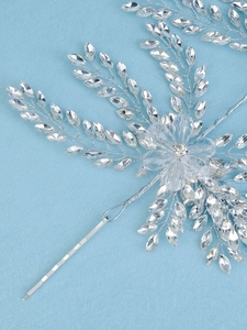 Close-up of luxury crystal bridal headband featuring marquise rhinestones and flower detail