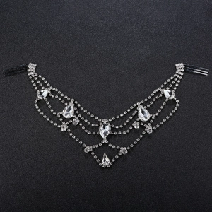 Detailed view of silver rhinestone bridal hair comb with layered chains and pear-cut pendants