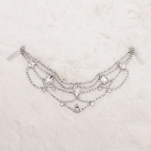 Macro detail of luxury silver fringe hair comb with sparkling crystal tassels and gemstones