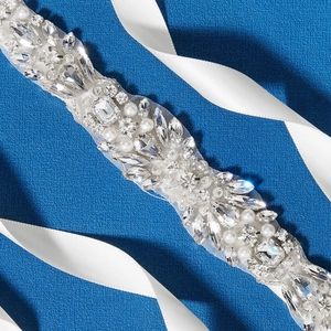 Detail of luxury bridal belt featuring white pearls and silver rhinestones on ribbon