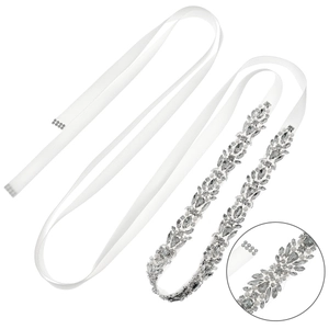 Close-up detail of silver crystal leaf bridal belt with white satin ribbon and claw setting