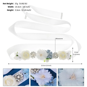 Detailed close-up showing white fabric flowers and silver rhinestones on bridal belt