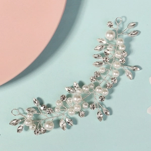 Detail of silver bridal headband featuring handmade pearls and sparkling rhinestones