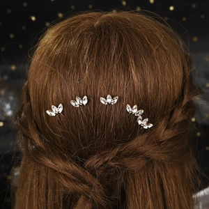 Detail of five sparkling rhinestone hair pins styled in a sophisticated bridal hairstyle