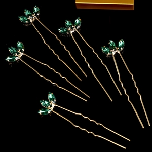 Detail of 5-piece gold U-shaped hair pins with green marquise crystal leaves