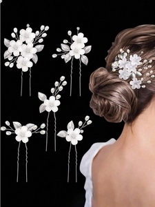 Detailed set of white acrylic flower bridal hair pins with pearls and silver leaves