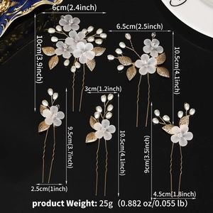 Detailed view of handmade bridal hair pins set with white petals, pearls and golden leaves