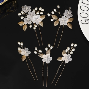 Handmade bridal hair pin set with white flowers and golden leaves for elegant wedding styling
