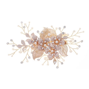 Detail of handmade bridal hair clip with pink fabric flowers, pearls and crystals