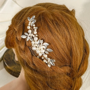 Elegant bridal silver hair comb with white pearls and leaves in a brown updo