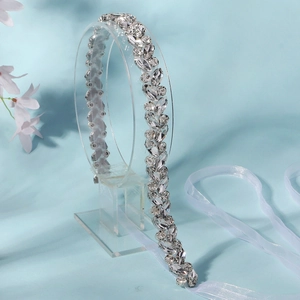 Detailed macro view of handmade rhinestone bridal sash belt with white organza ribbons