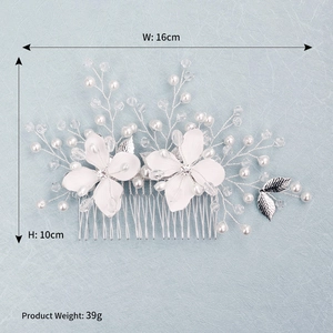 Detail view of handmade bridal hair comb with white flowers, pearls and crystals