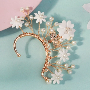 Macro detail of handmade floral ear cuff with white beads and pearls on wire