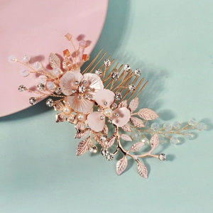 Detail showing crystal beads and rose gold flower petals on bridal hair comb