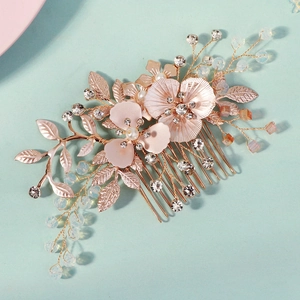 Floral crystal hair comb with pink petals and gold leaves for bridal hairstyles
