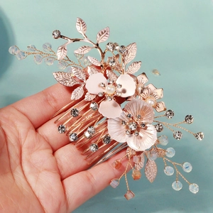 Detailed shot of rose gold floral hair comb with crystal beads and pearls for bridal styles