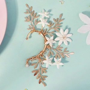 Detail of floral golden ear cuff with white handmade clay beads and pearls